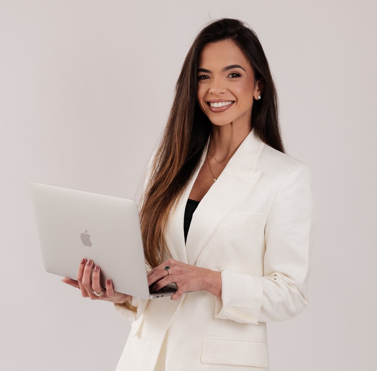 Dra. Letícia Taff com notebook em retrato profissional